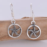 E622 - Starfish inside disc silver earrings